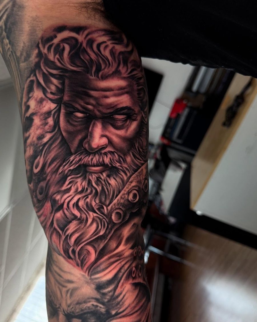 Bearded god portrait, a black and grey realism tattoo by Jeremy Sramek