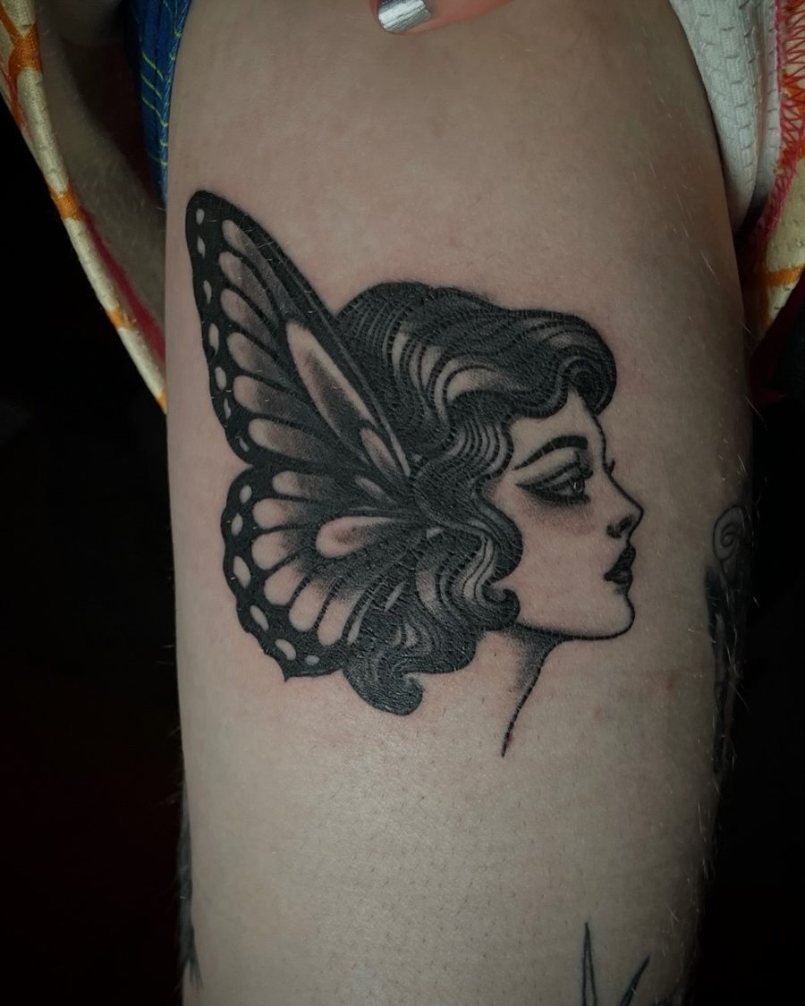 Lady head with butterfly wings, a blackwork tattoo by Kain Sramek