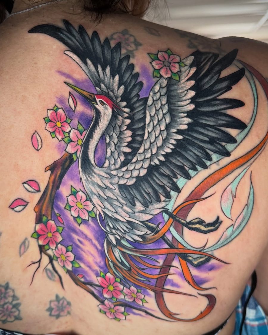 Crane with cherry blossoms, a full color upper back tattoo by Jeremy Sramek