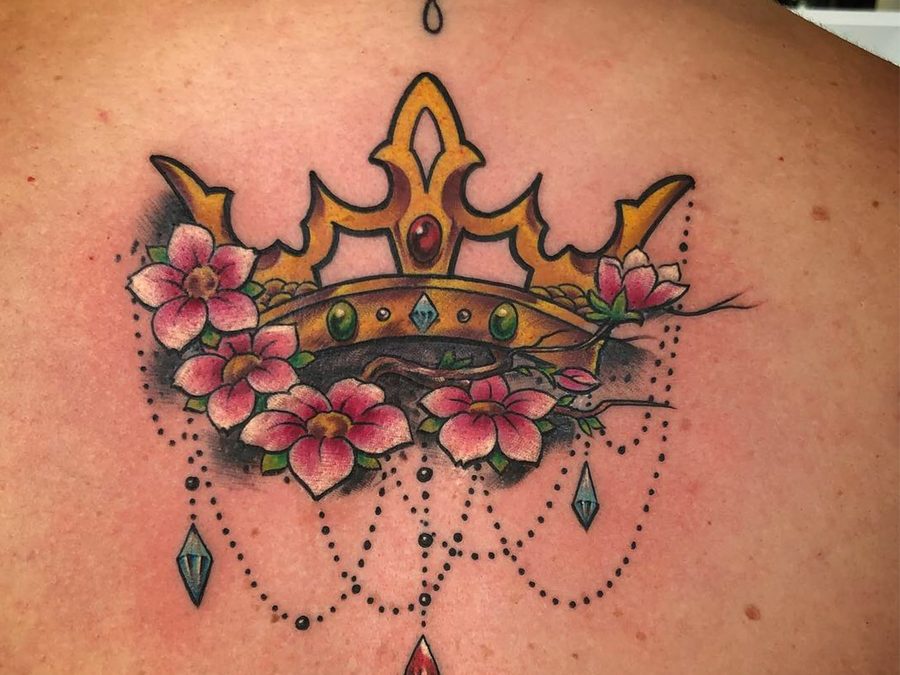Crown and cherry blossoms tattoo in full color on an upper back by Jeremy Sramek