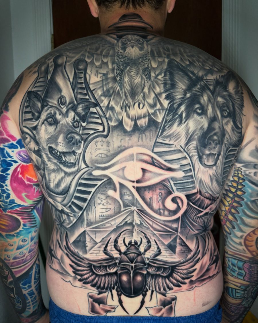 Egyptian back piece tattoo with the client's dogs as the gods, black and grey, by Jeremy Sramek