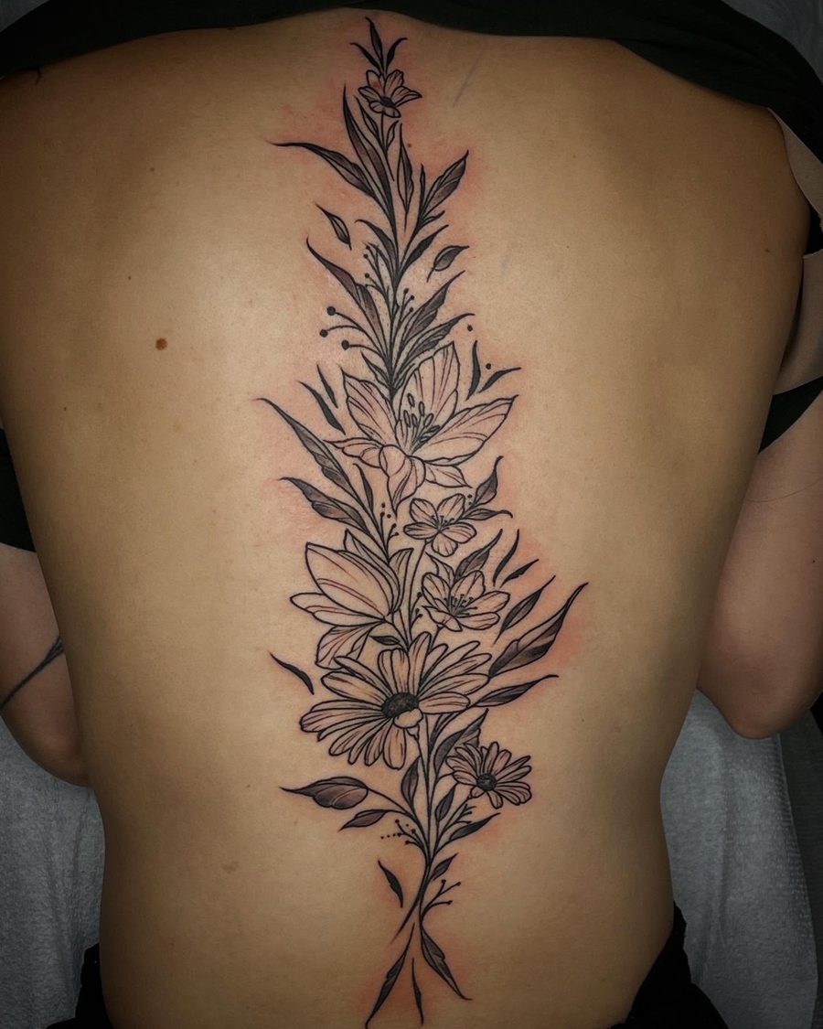 Fine line floral spine tattoo by Jeremy Sramek