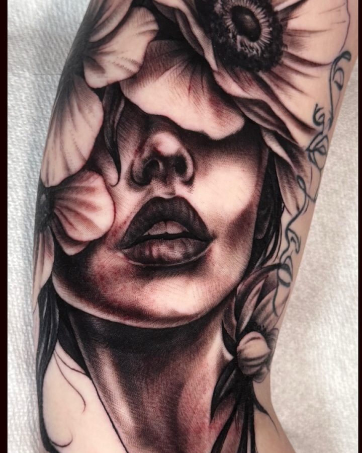 Flower-face portrait tattoo in black and grey by Jeremy Sramek