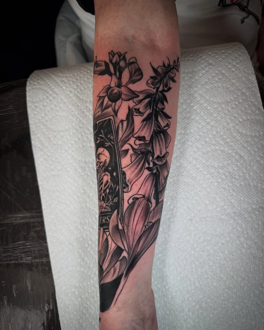 Foxglove and bellflower forearm tattoo in black and grey by Jeremy Sramek