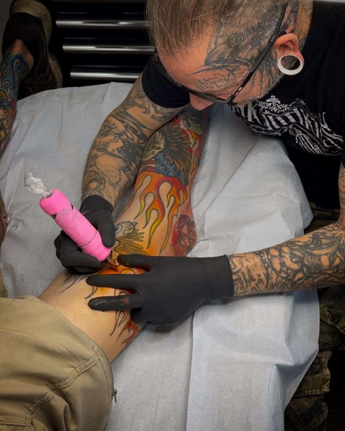 Jeremy Sramek tattooing a color flame piece at Vanity Ink in Wheat Ridge