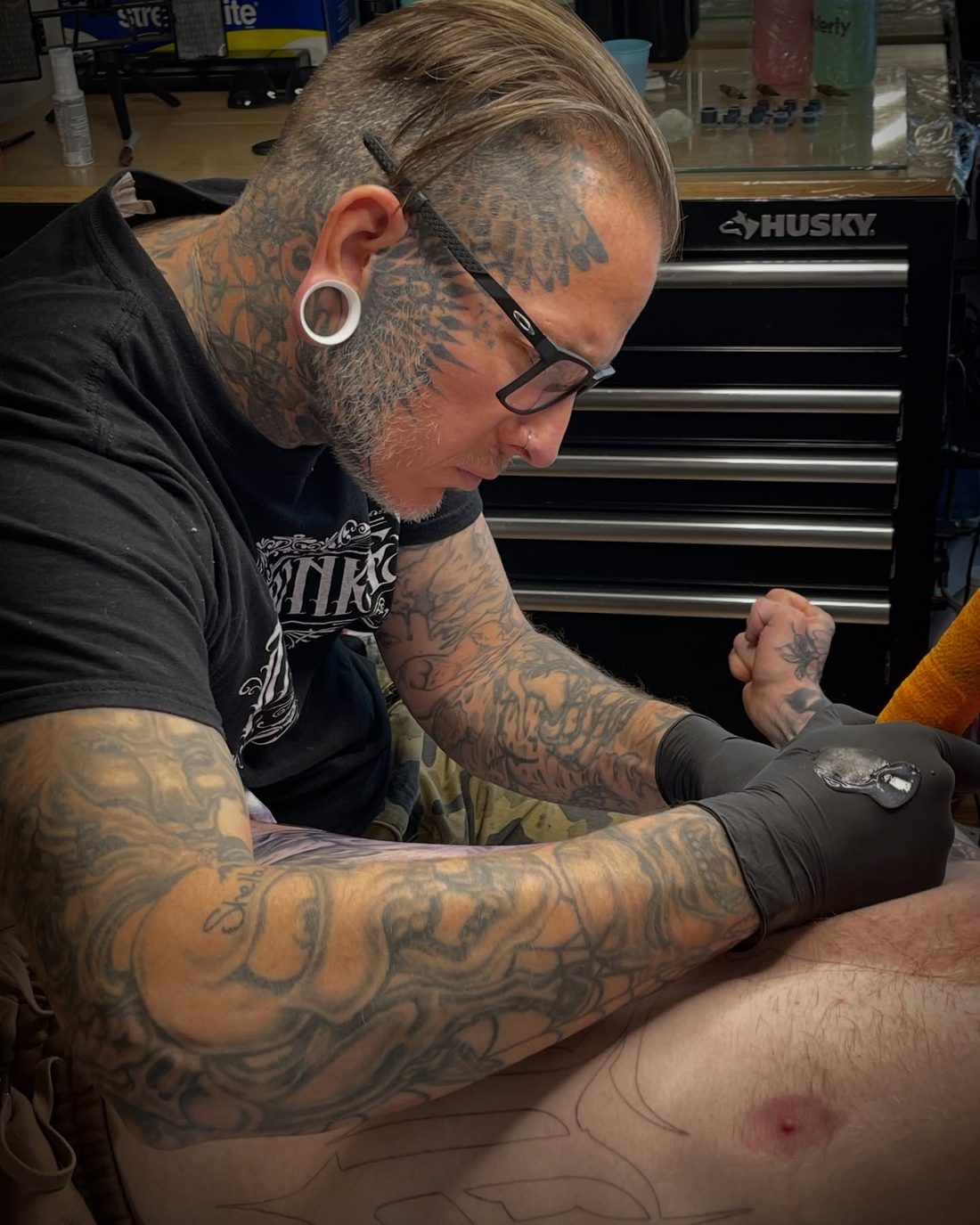 Jeremy Sramek tattooing a client at Vanity Ink Tattoo Studio in Wheat Ridge