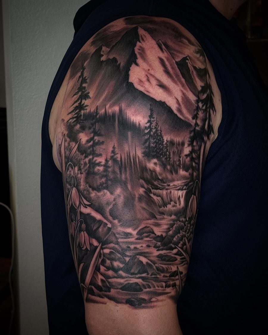 Mountains, forest and moon, a black and grey shoulder tattoo by Jeremy Sramek