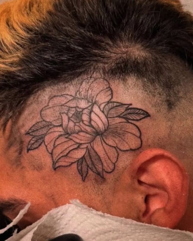 Linework peony tattoo on the side of the head by Kain Sramek