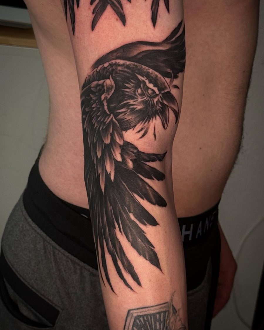 Raven wing blackwork forearm tattoo by Jeremy Sramek