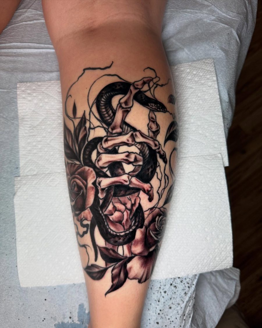 Snake and roses blackwork tattoo by Jeremy Sramek
