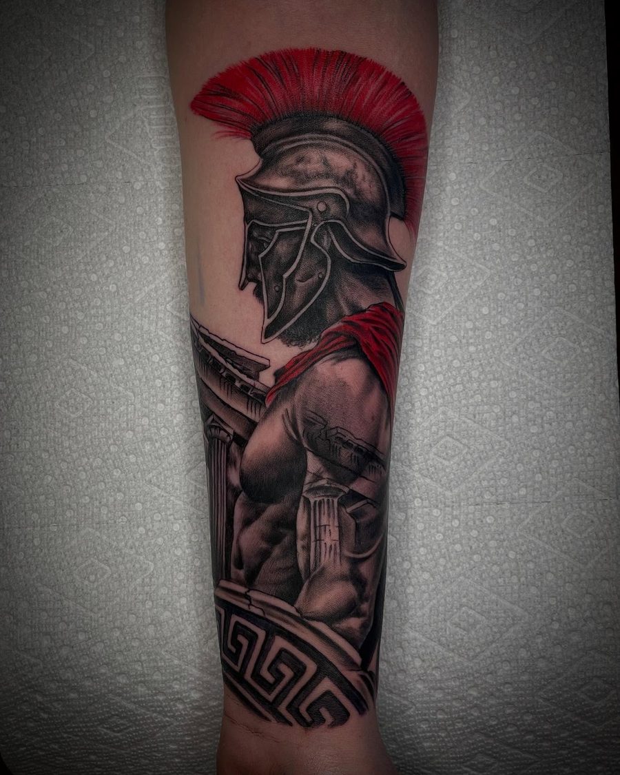 Spartan warrior forearm tattoo in black and red by Jeremy Sramek