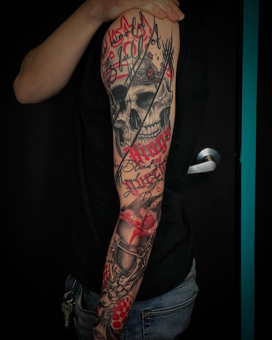 Trash Polka skull sleeve tattoo in red and black by Jeremy Sramek