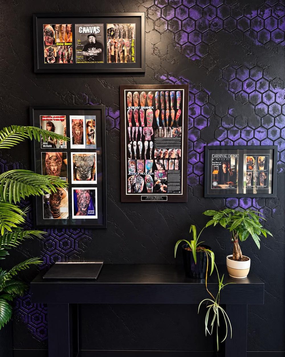 Framed tattoo work on the honeycomb wall at Vanity Ink
