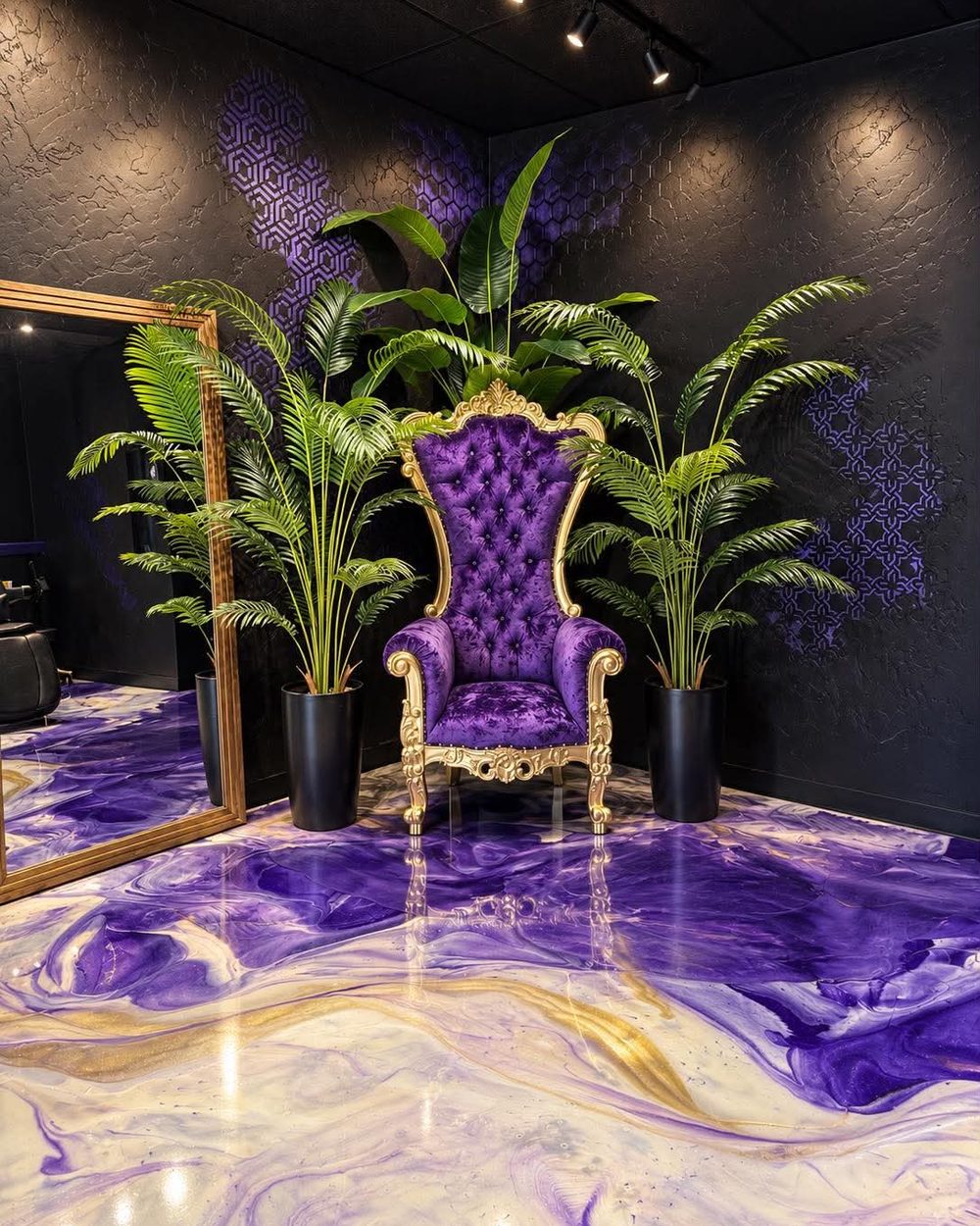 The purple throne between palms on the marble epoxy floor at Vanity Ink in Wheat Ridge